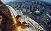 "رجل عنكبوت" تسلق مبنى شاهق من تصميم معمارية عراقية في بكين