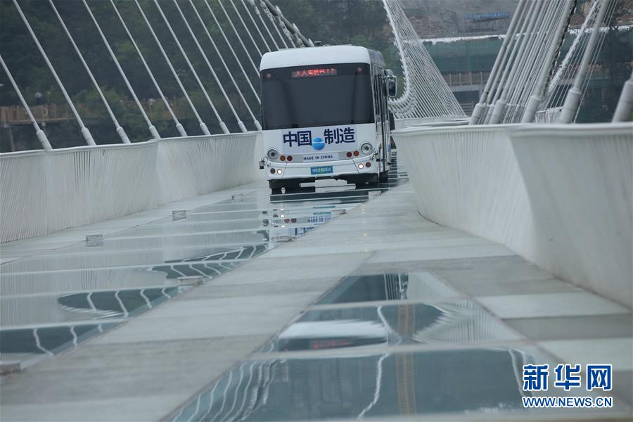 حافلة تتحدى صلابة جسر زجاجي معلق بهونان