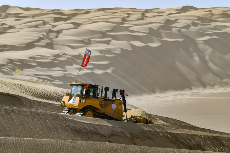 بالصور: العمل الشاق لبناء طريق صحراوي سريع في تاكليماكان بشينجيانغ